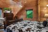 Upper level king bedroom with twin bed & log decor Upper level king bedroom with twin bed & log decor