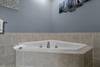 Lower level ensuite with jacuzzi tub & standing shower Lower level ensuite with jacuzzi tub & standing shower