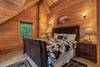 Upper level king bedroom with twin bed & log decor Upper level king bedroom with twin bed & log decor