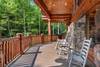 Wrap-around deck with rocking chairs & forest views Wrap-around deck with rocking chairs & forest views