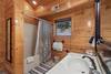Upper level ensuite with tub/shower & mountain decor Upper level ensuite with tub/shower & mountain decor