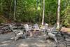 Fire pit area with log seating by the creek Fire pit area with log seating by the creek