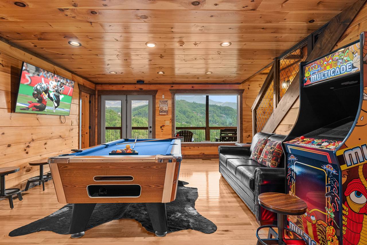 Lower level game room with pool table, arcage game, & TV Lower level game room with pool table, arcage game, & TV