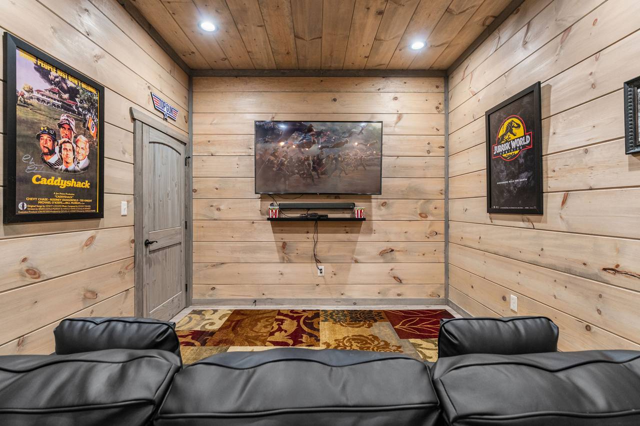 Catch a movie in the theater room with recliners and sofa seatin Catch a movie in the theater room with recliners and sofa seatin
