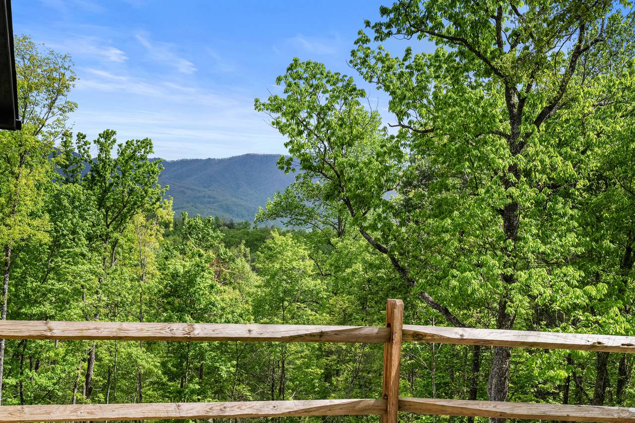 Relax on the deck with seating and Smoky Mountain views Relax on the deck with seating and Smoky Mountain views