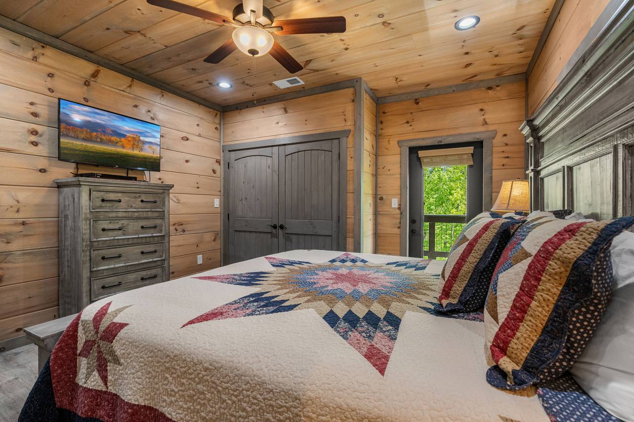 Main level king bedroom with TV and private ensuite bath Main level king bedroom with TV and private ensuite bath