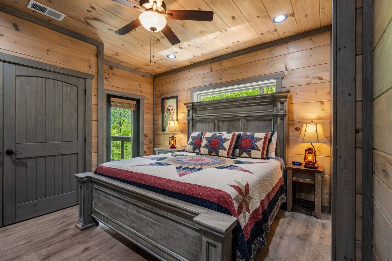 Main level king bedroom with TV and private ensuite bath Main level king bedroom with TV and private ensuite bath