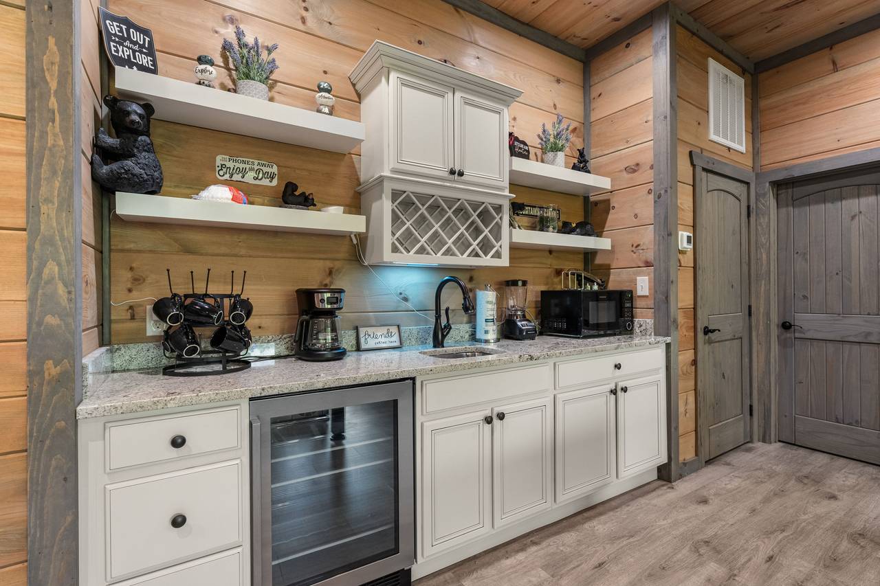 Lounge in style with a fireplace, wet bar, and cozy seating! Lounge in style with a fireplace, wet bar, and cozy seating!