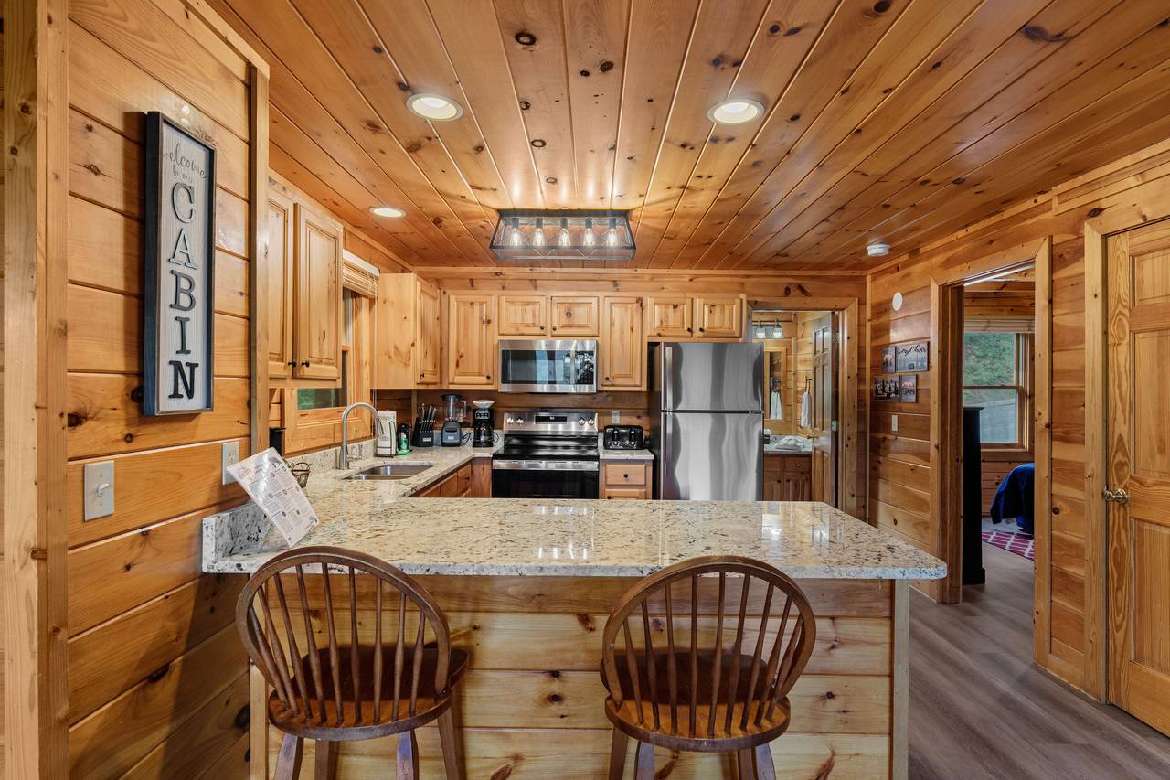 Kitchen with counter seating for casual dining & socializing. Kitchen with counter seating for casual dining & socializing.