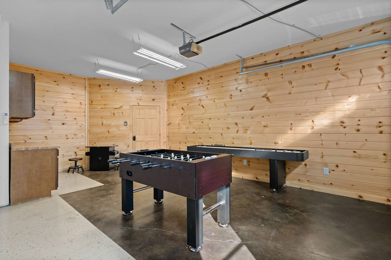 Game room with arcade, foosball & shuffleboard Game room with arcade, foosball & shuffleboard