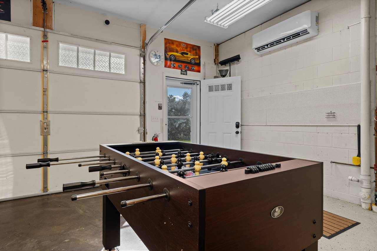 Game room with arcade, foosball & shuffleboard Game room with arcade, foosball & shuffleboard