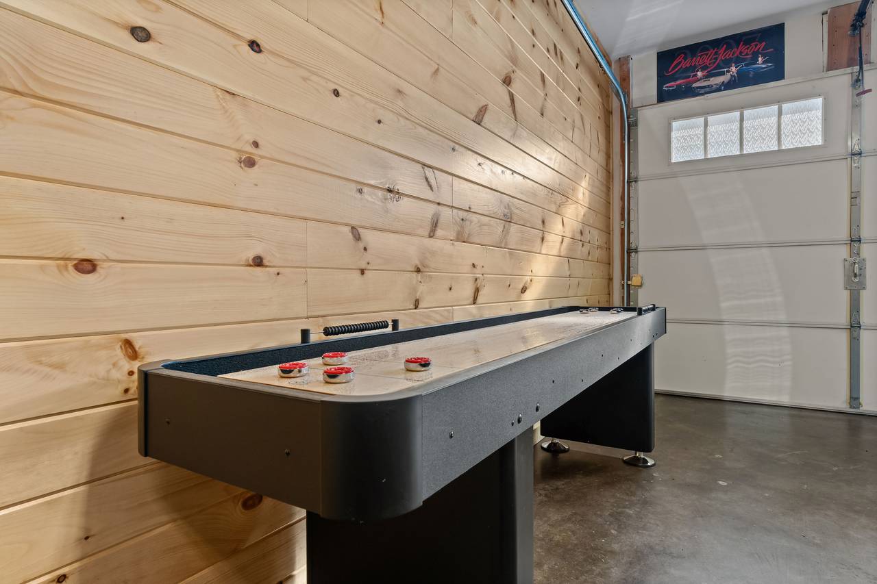 Game room with arcade, foosball & shuffleboard Game room with arcade, foosball & shuffleboard