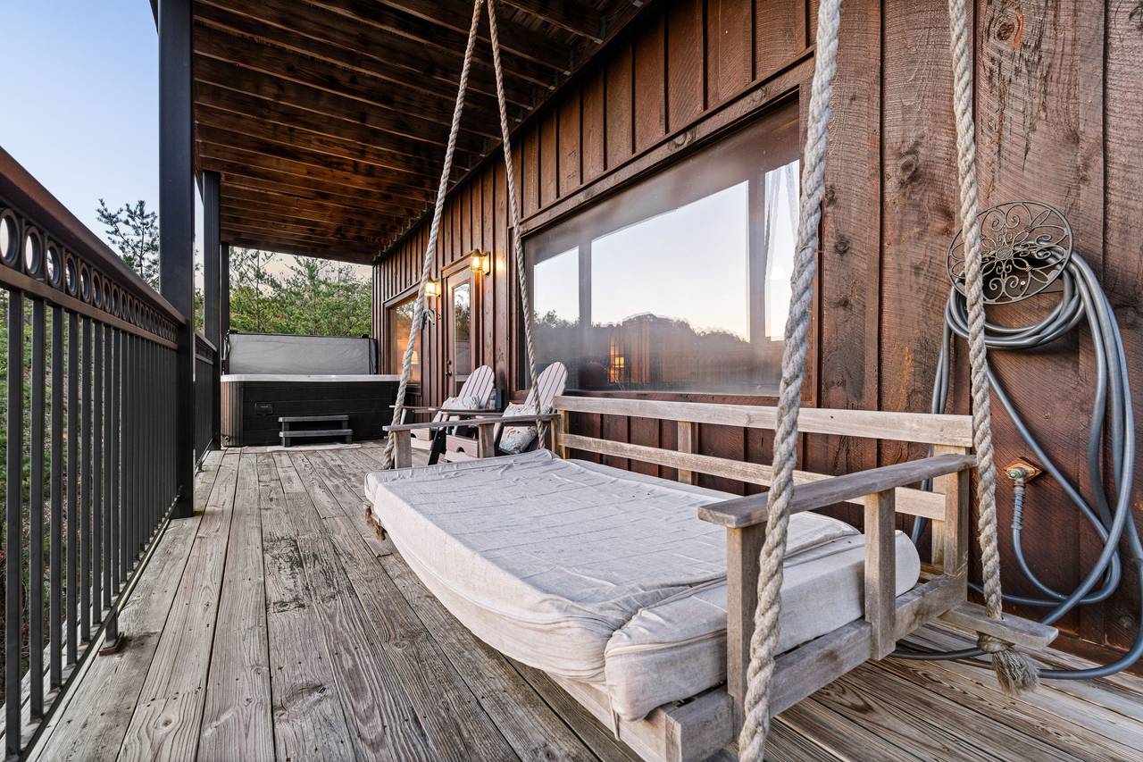 <span class="name">Lower walkout deck with swing & wooded mountain views</span> <span class="name">Lower walkout deck with swing & wooded mountain views</span>