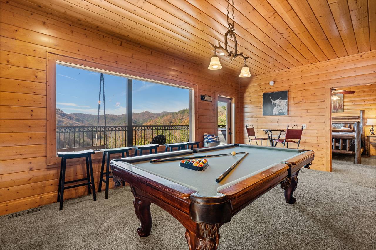 <span class="name">Game room with pool table & cozy lodge-style décor</span> <span class="name">Game room with pool table & cozy lodge-style décor</span>