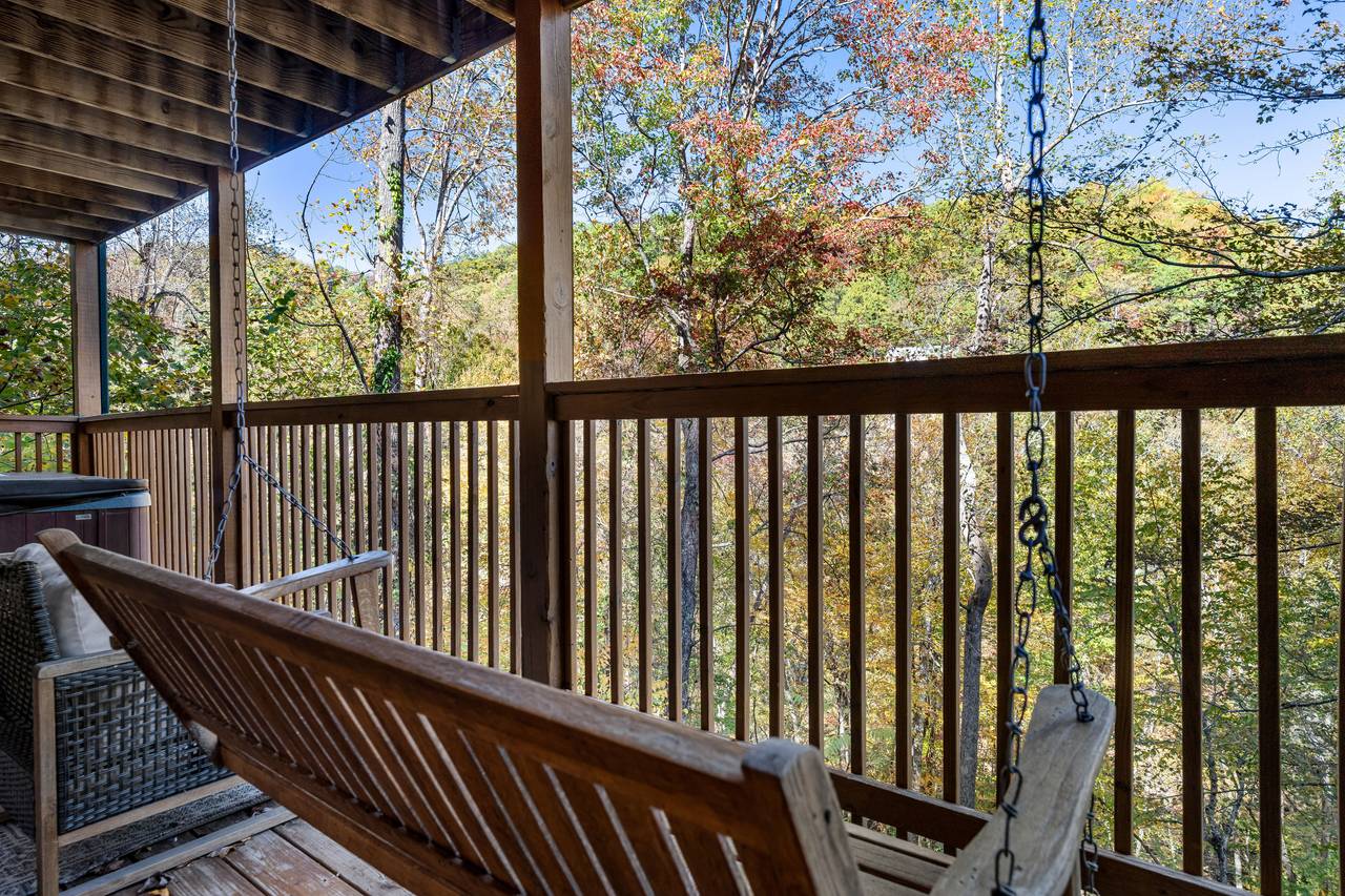 Rocking chairs & porch swing with peaceful forest views Rocking chairs & porch swing with peaceful forest views