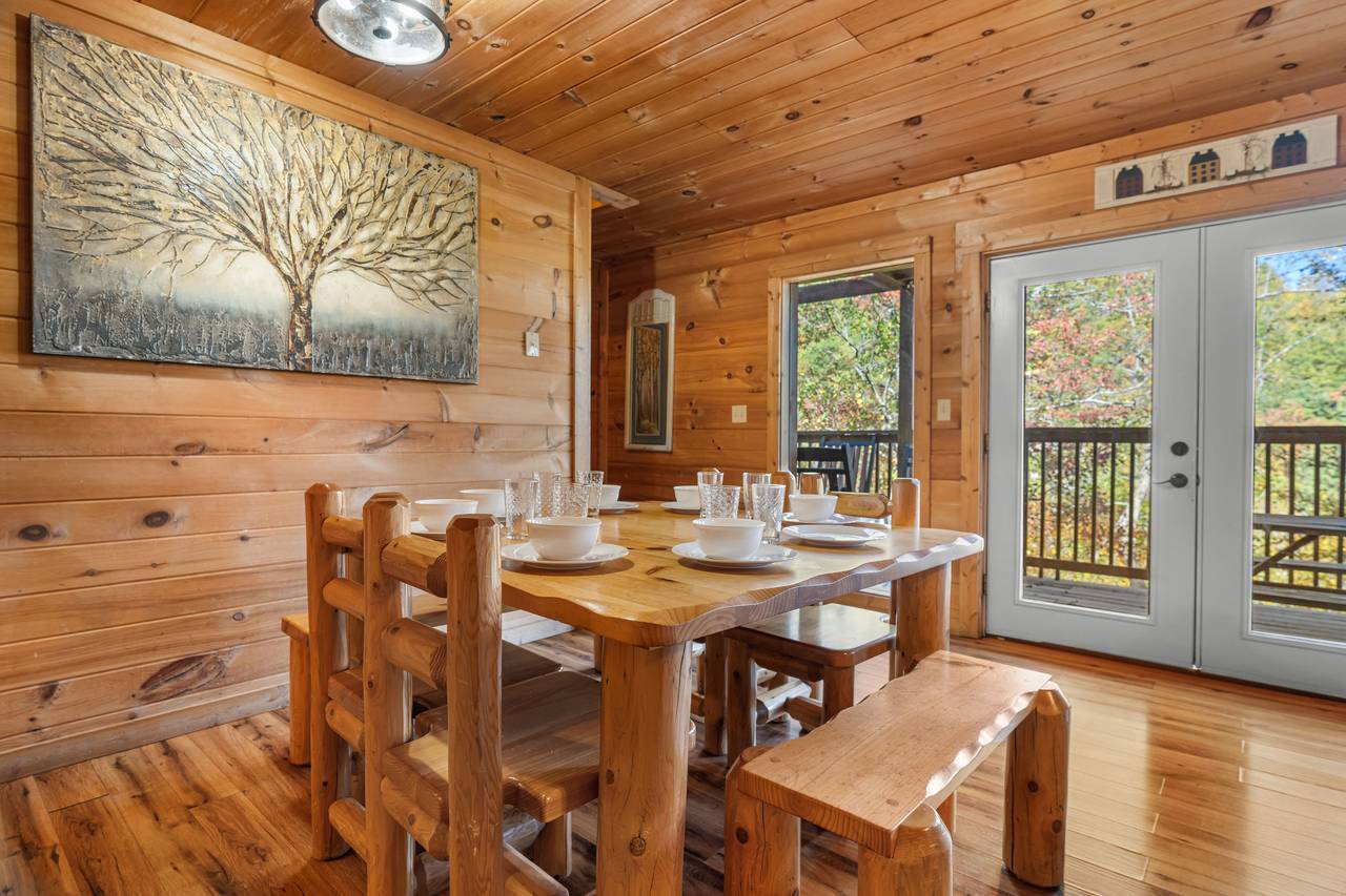 Log dining table for eight with scenic wooded views Log dining table for eight with scenic wooded views