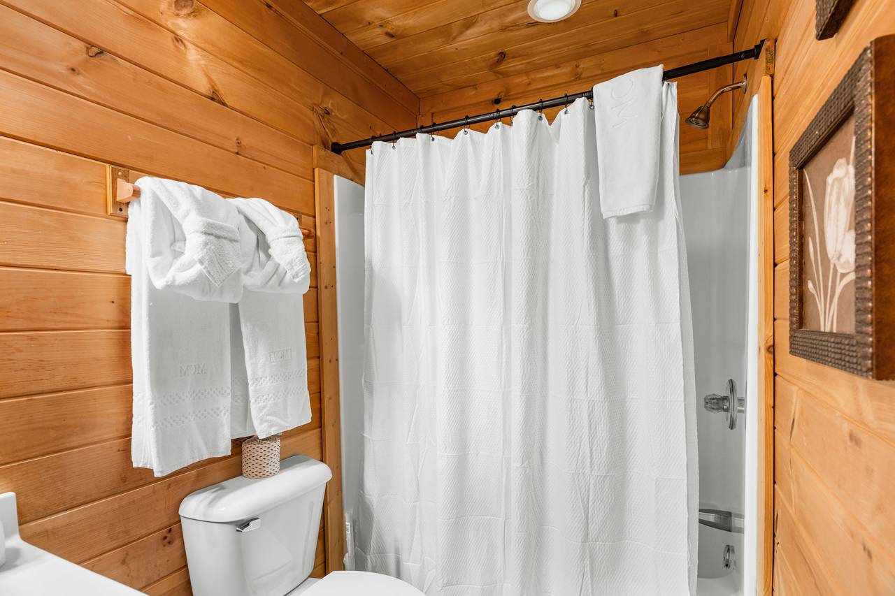 Main level ensuite full bath with tub and shower combo Main level ensuite full bath with tub and shower combo