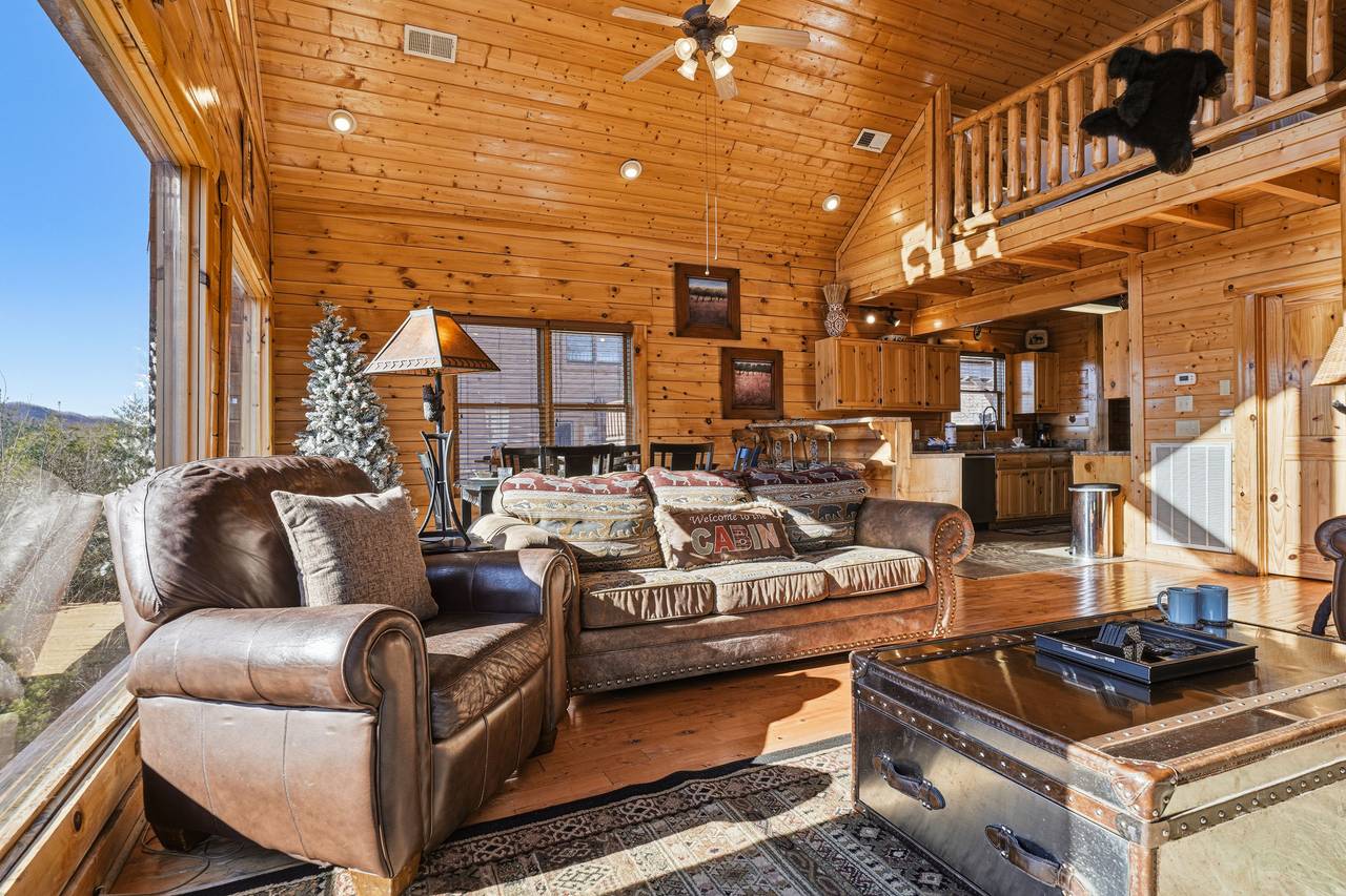 <span class="name">Main level living room with sleeper sofa, TV, & fireplace</span> <span class="name">Main level living room with sleeper sofa, TV, & fireplace</span>
