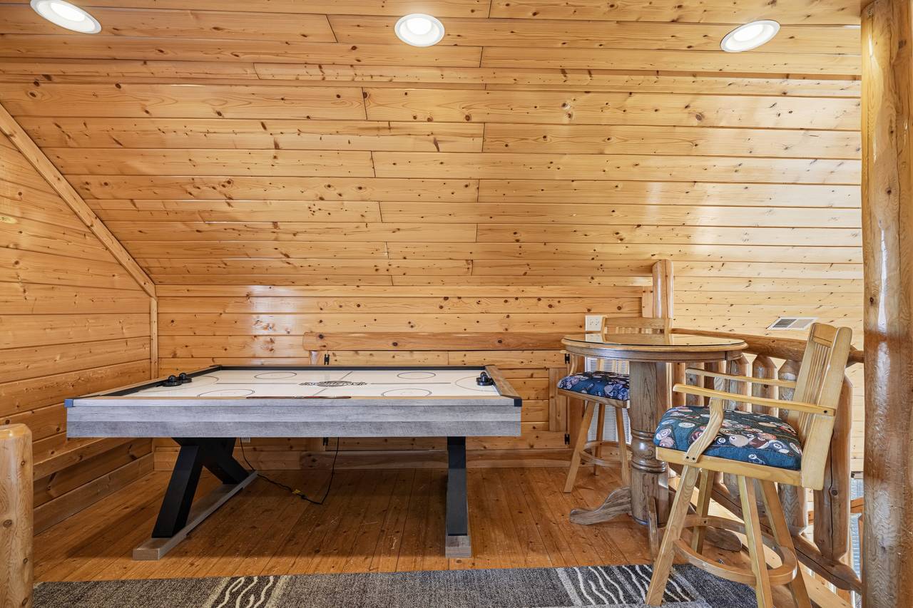 <span class="name">Loft bedroom with two queen beds, seating area, & air hockey</span> <span class="name">Loft bedroom with two queen beds, seating area, & air hockey</span>