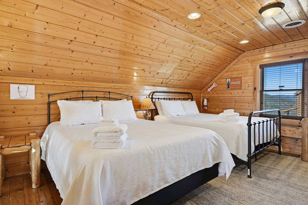 <span class="name">Loft bedroom with two queen beds, seating area, & air hockey</span> <span class="name">Loft bedroom with two queen beds, seating area, & air hockey</span>