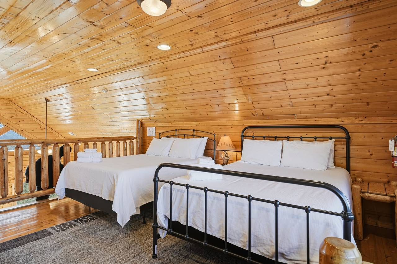 <span class="name">Loft bedroom with two queen beds, seating area, & air hockey</span> <span class="name">Loft bedroom with two queen beds, seating area, & air hockey</span>