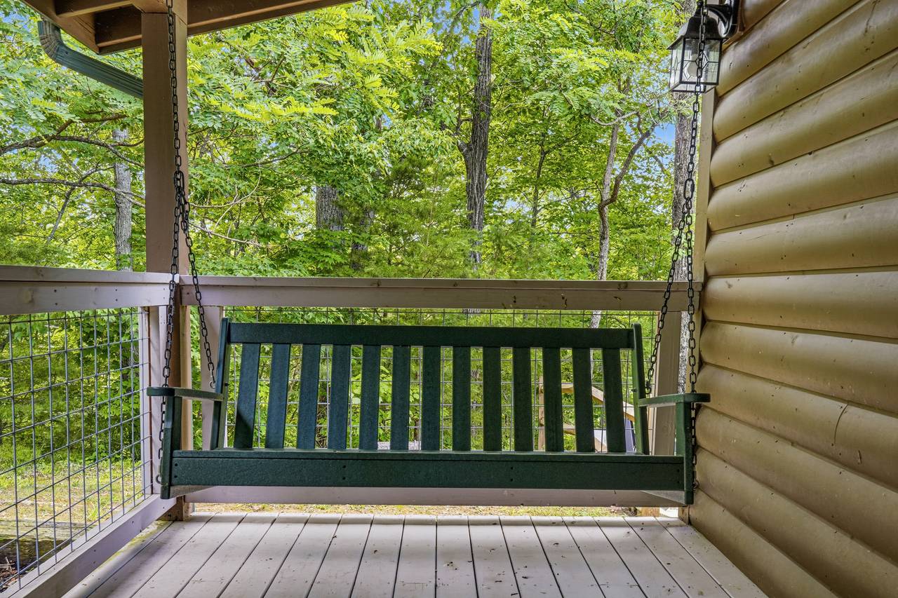 Porch swing overlooking the peaceful mountain setting Porch swing overlooking the peaceful mountain setting