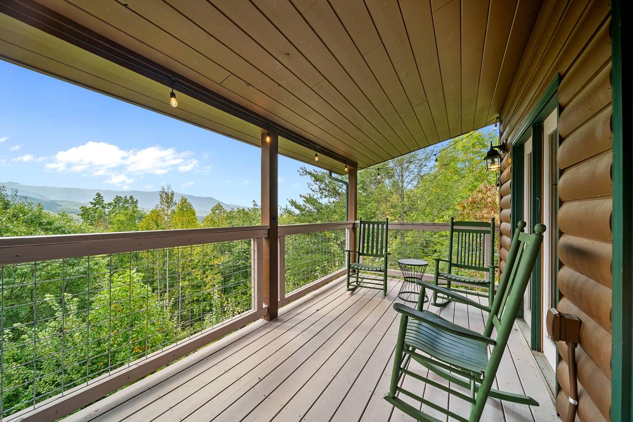 Covered deck with rocking chairs and mountain serenity Covered deck with rocking chairs and mountain serenity