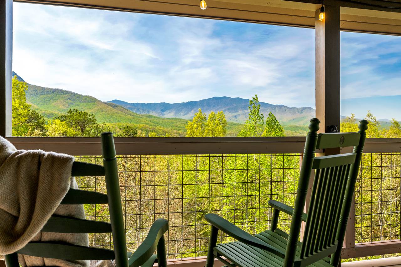 Covered deck with rocking chairs and mountain serenity Covered deck with rocking chairs and mountain serenity