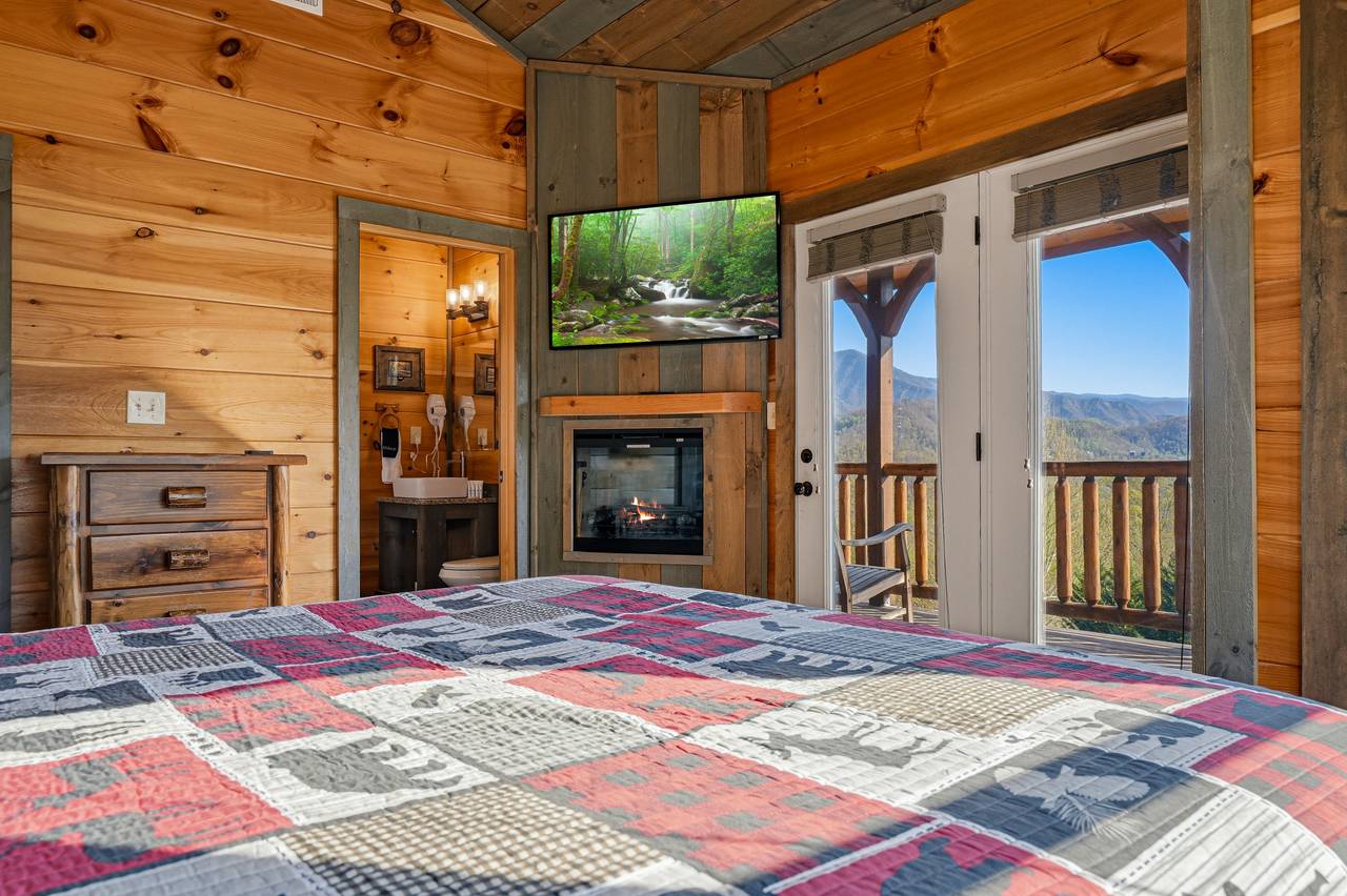 King suite with ensuite bath, TV, fireplace, and deck access King suite with ensuite bath, TV, fireplace, and deck access