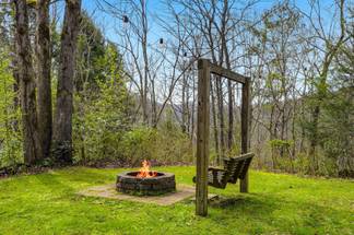 Outdoor swing around fire pit for cozy nights Outdoor swing around fire pit for cozy nights