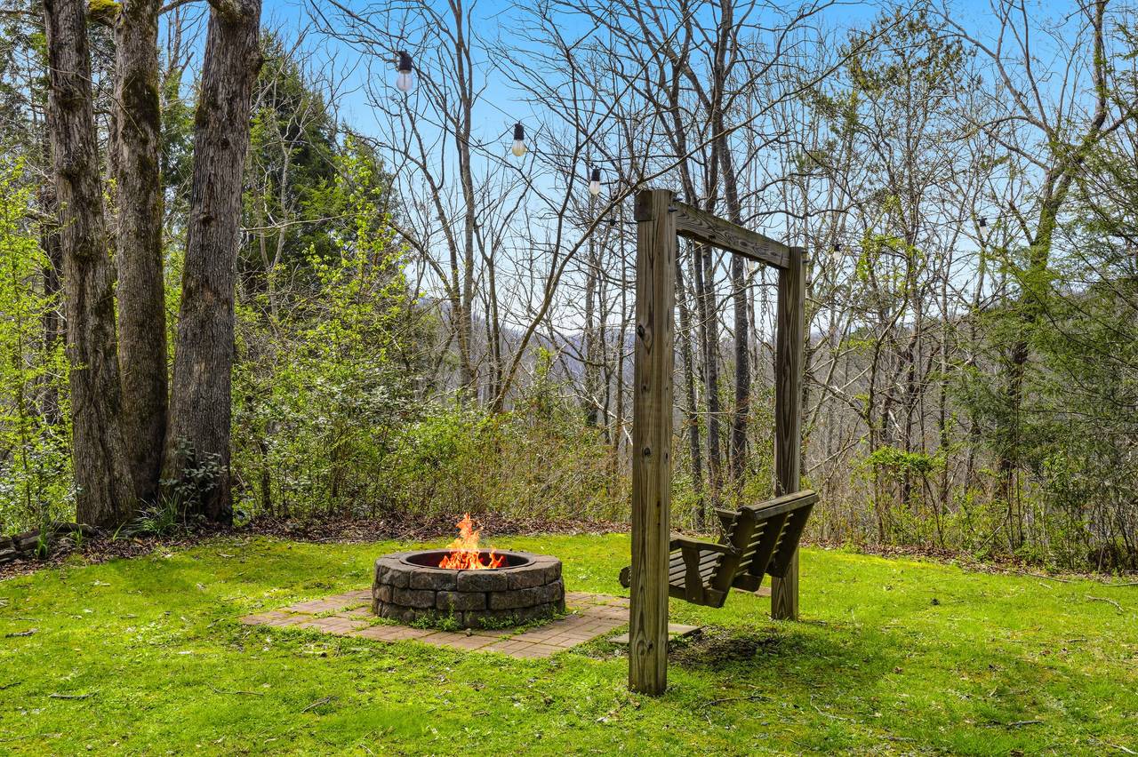 Outdoor swing around fire pit for cozy nights Outdoor swing around fire pit for cozy nights