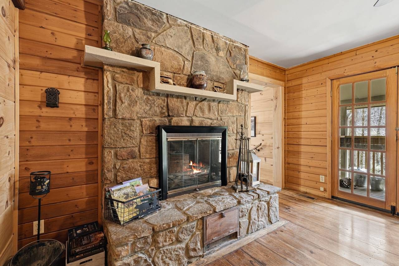 Cozy living room with wood-burning fireplace & seating Cozy living room with wood-burning fireplace & seating