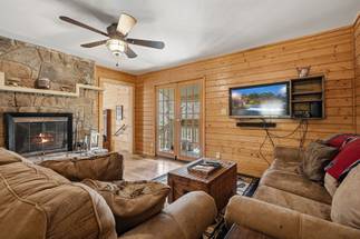 Cozy living room with wood-burning fireplace & seating Cozy living room with wood-burning fireplace & seating