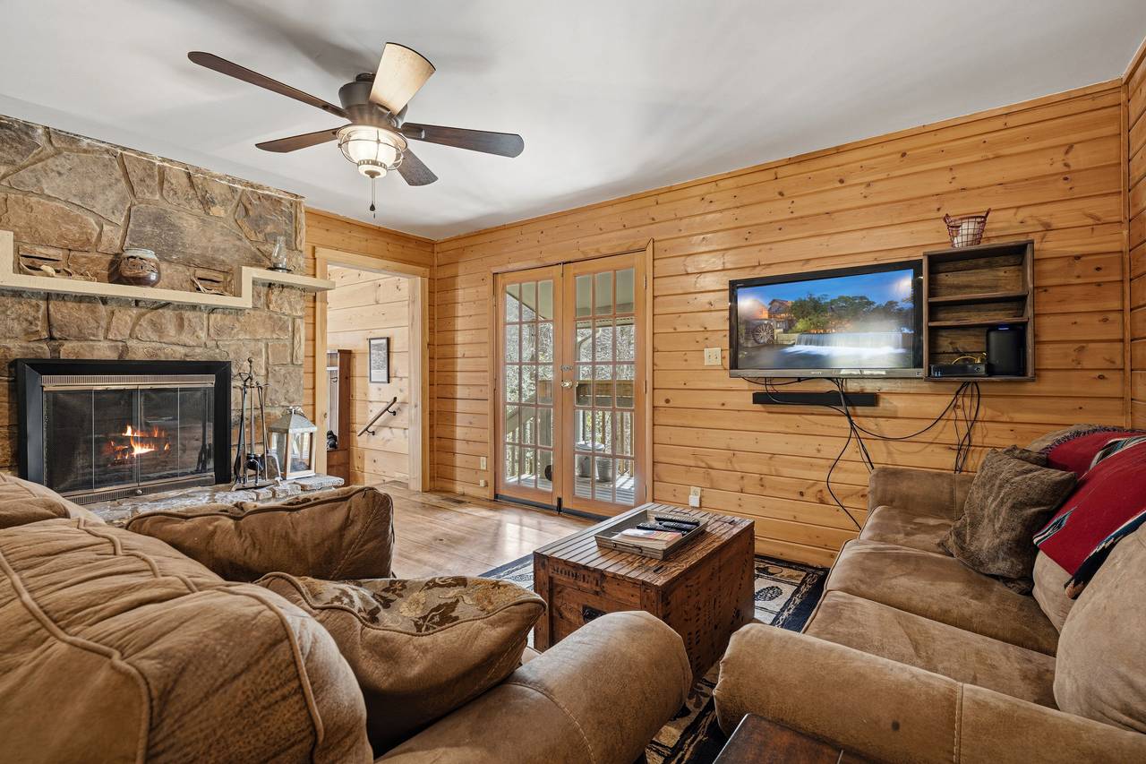 Cozy living room with wood-burning fireplace & seating Cozy living room with wood-burning fireplace & seating