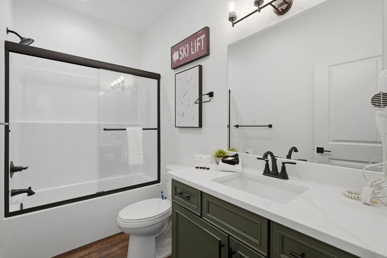 Bunk room ensuite with convenient tub & shower combo Bunk room ensuite with convenient tub & shower combo