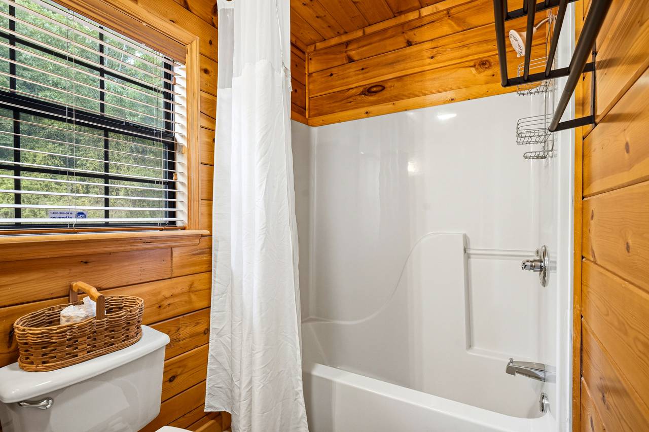 Main level ensuite full bath with tub and shower combo Main level ensuite full bath with tub and shower combo