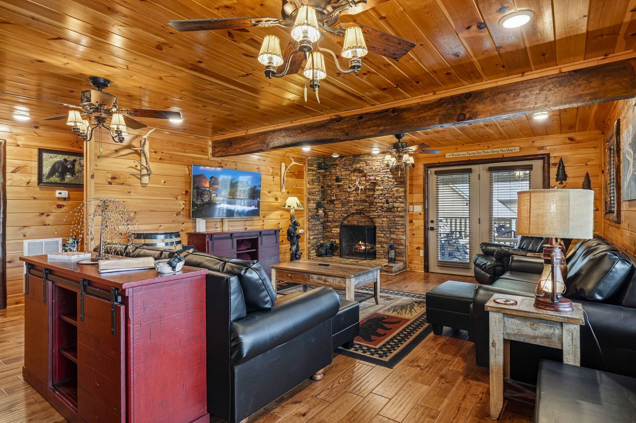 Gather in the cozy living room with stone fireplace Gather in the cozy living room with stone fireplace