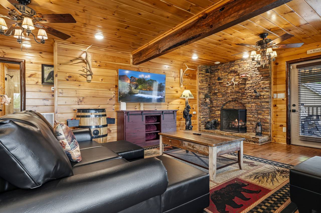 Gather in the cozy living room with stone fireplace Gather in the cozy living room with stone fireplace