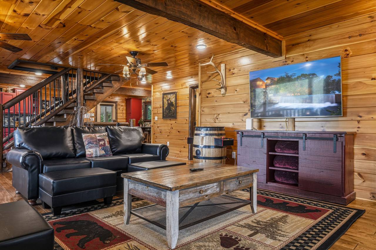 Gather in the cozy living room with stone fireplace Gather in the cozy living room with stone fireplace