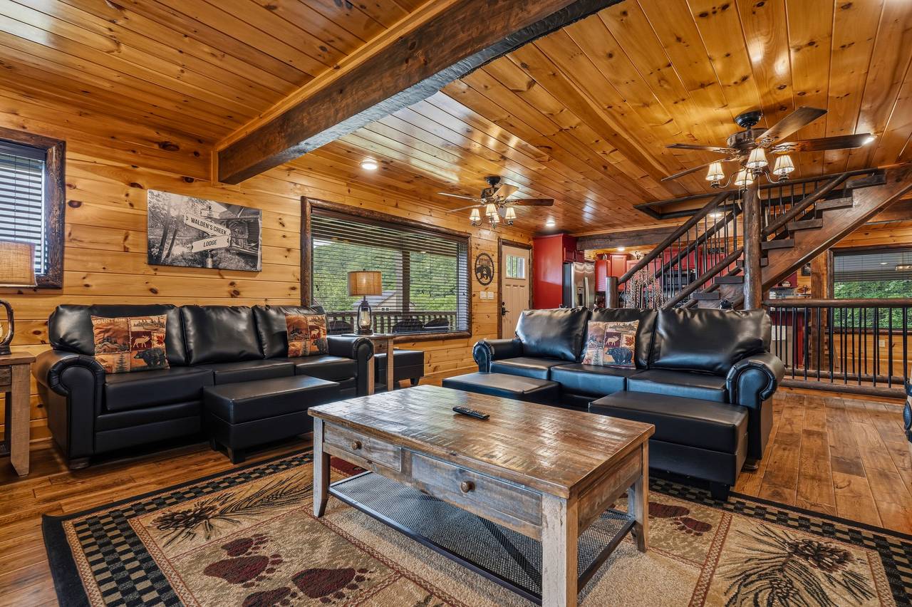 Gather in the cozy living room with stone fireplace Gather in the cozy living room with stone fireplace