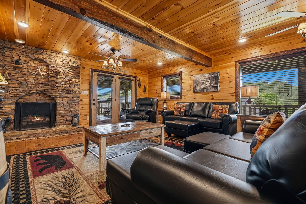 Gather in the cozy living room with stone fireplace Gather in the cozy living room with stone fireplace