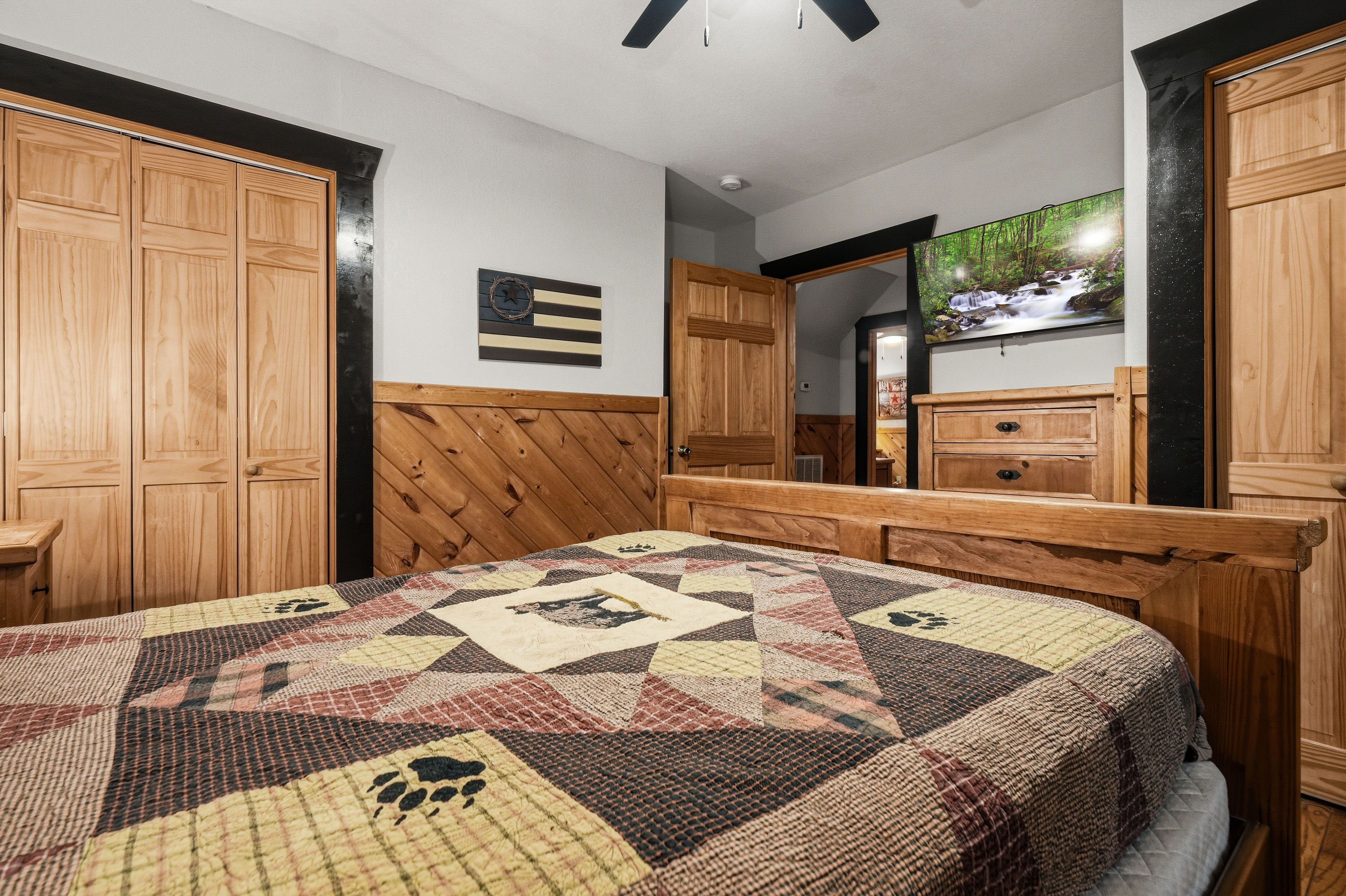 Lower-level queen bedroom with TV and ensuite bath access