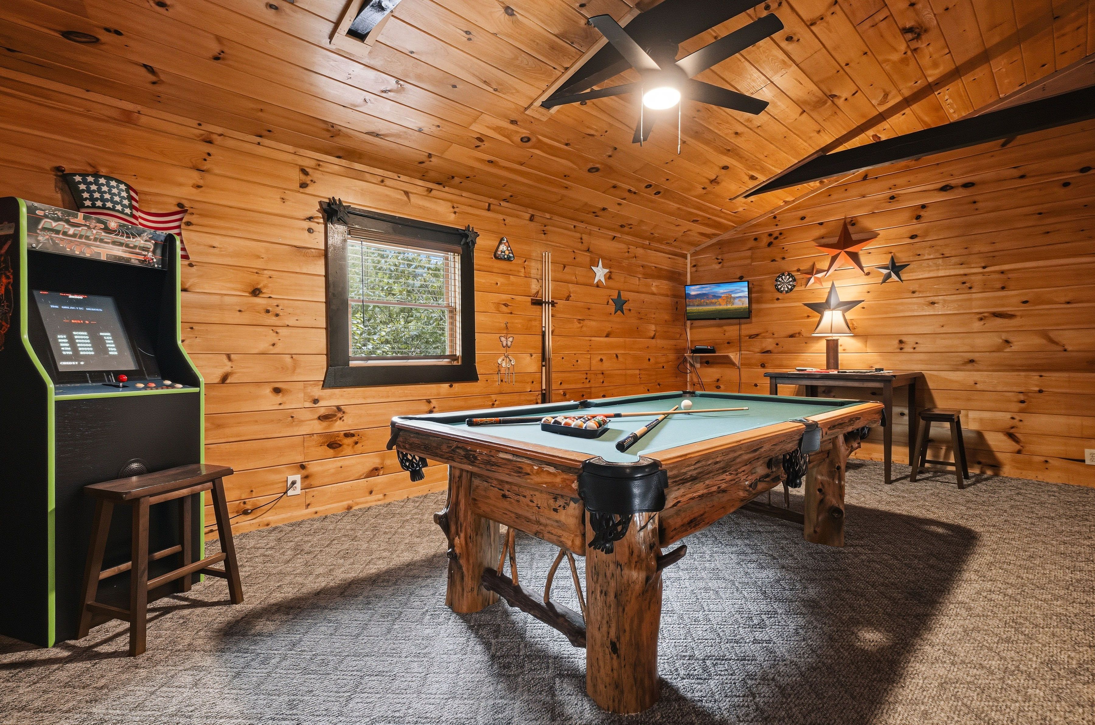 Game room with full-size pool table and multicade arcade