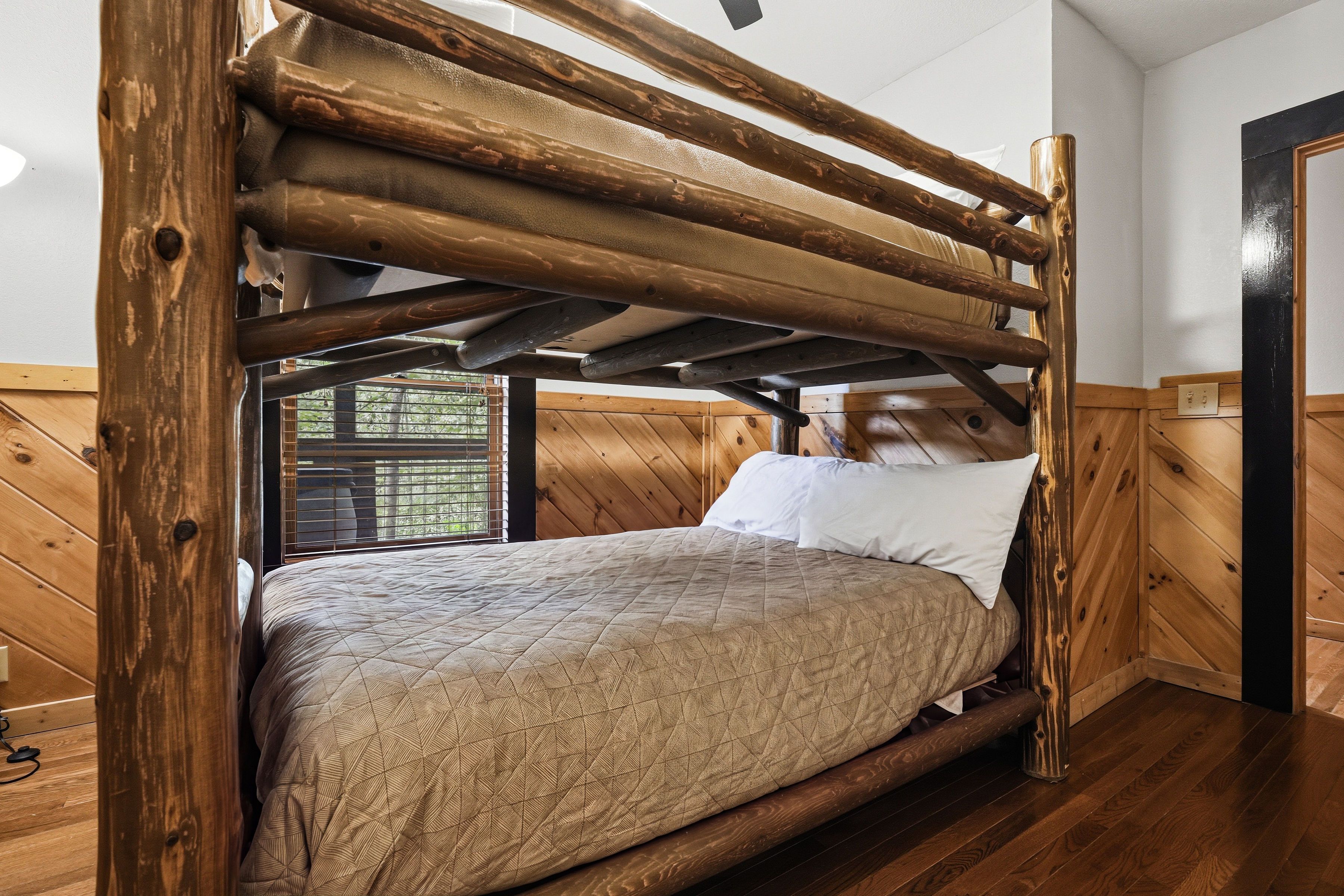 Lower-level bunk room with twin-over-full bunk bed and TV