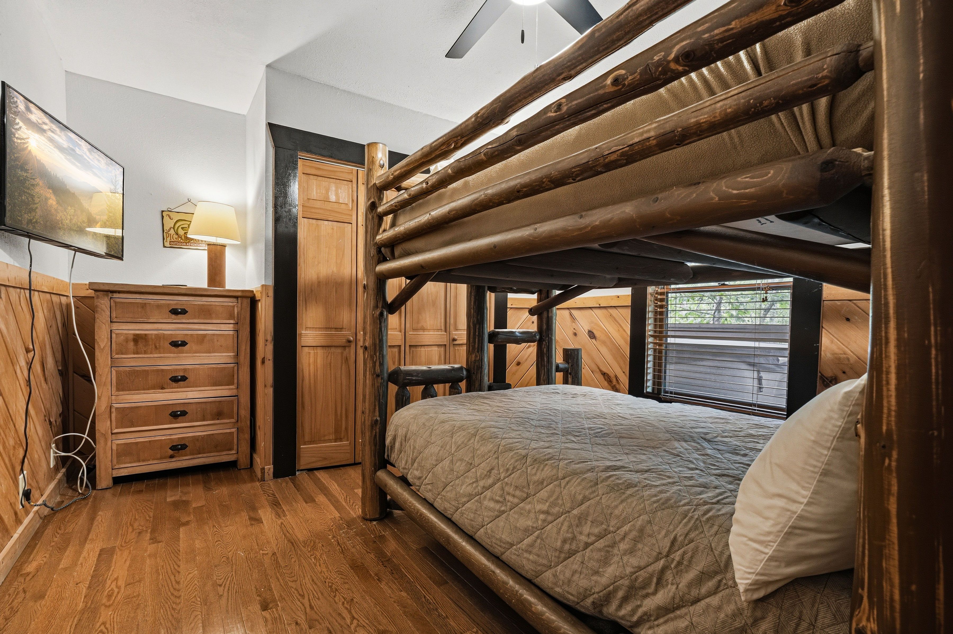 Lower-level bunk room with twin-over-full bunk bed and TV