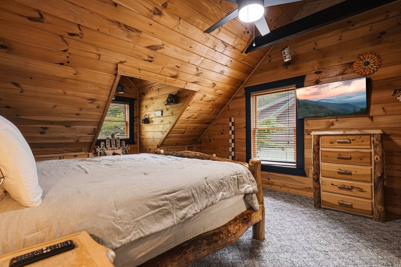 Upper-level king bedroom with TV and private ensuite bath Upper-level king bedroom with TV and private ensuite bath