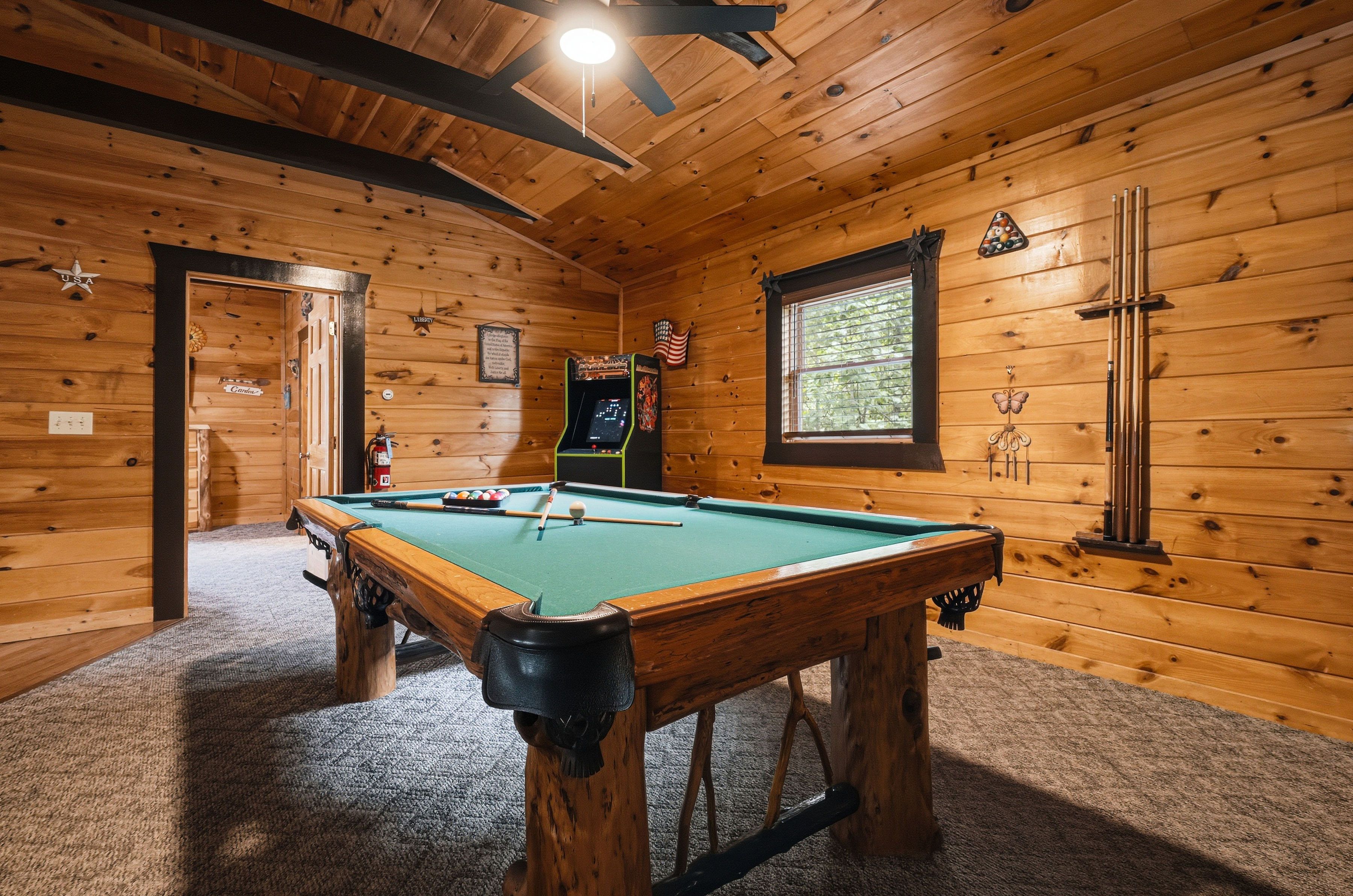 Game room with full-size pool table and multicade arcade