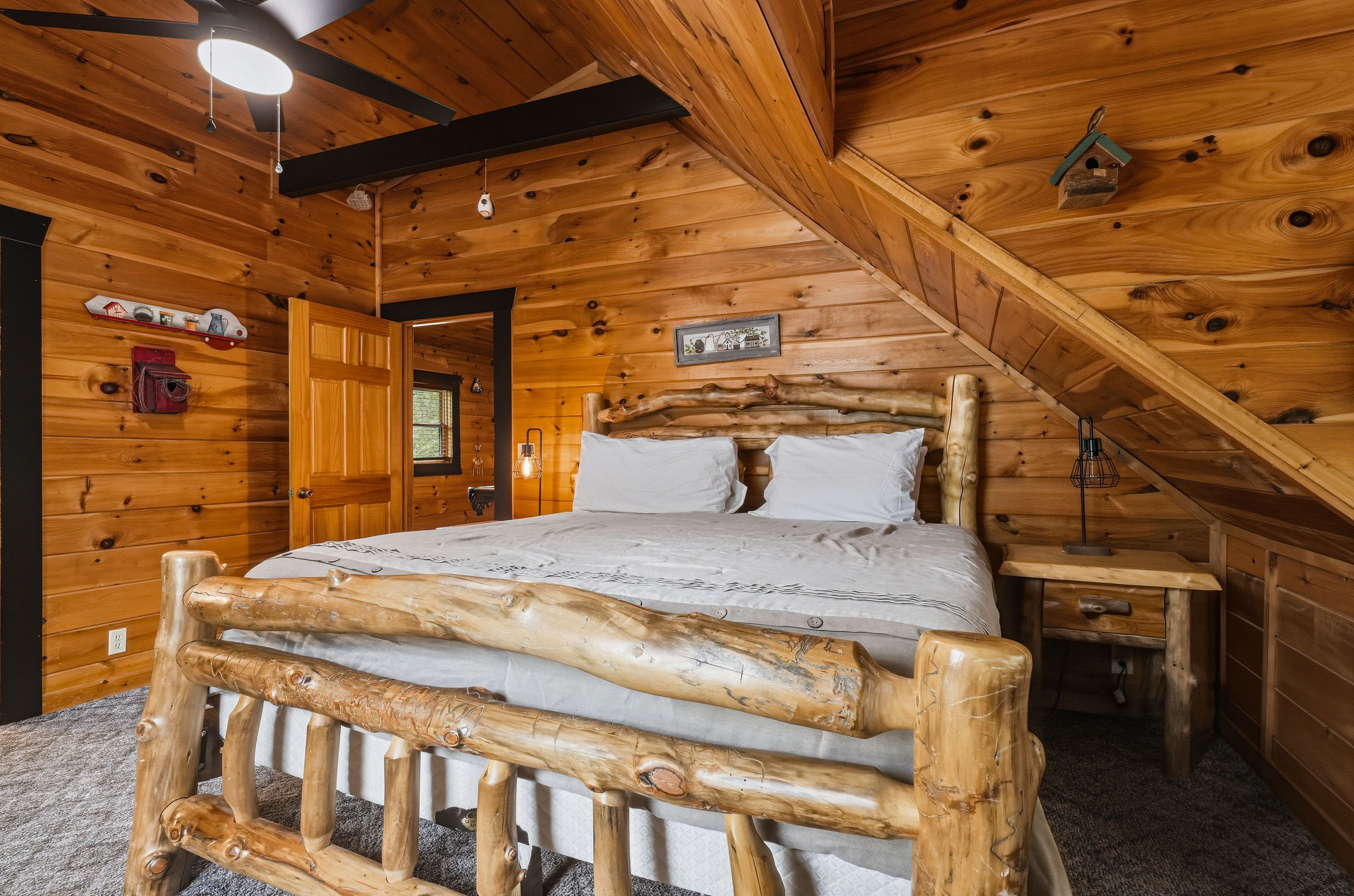 Upper-level king bedroom with TV and private ensuite bath