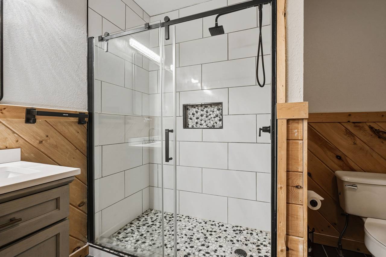 Lower-level shared bath with walk-in shower Lower-level shared bath with walk-in shower