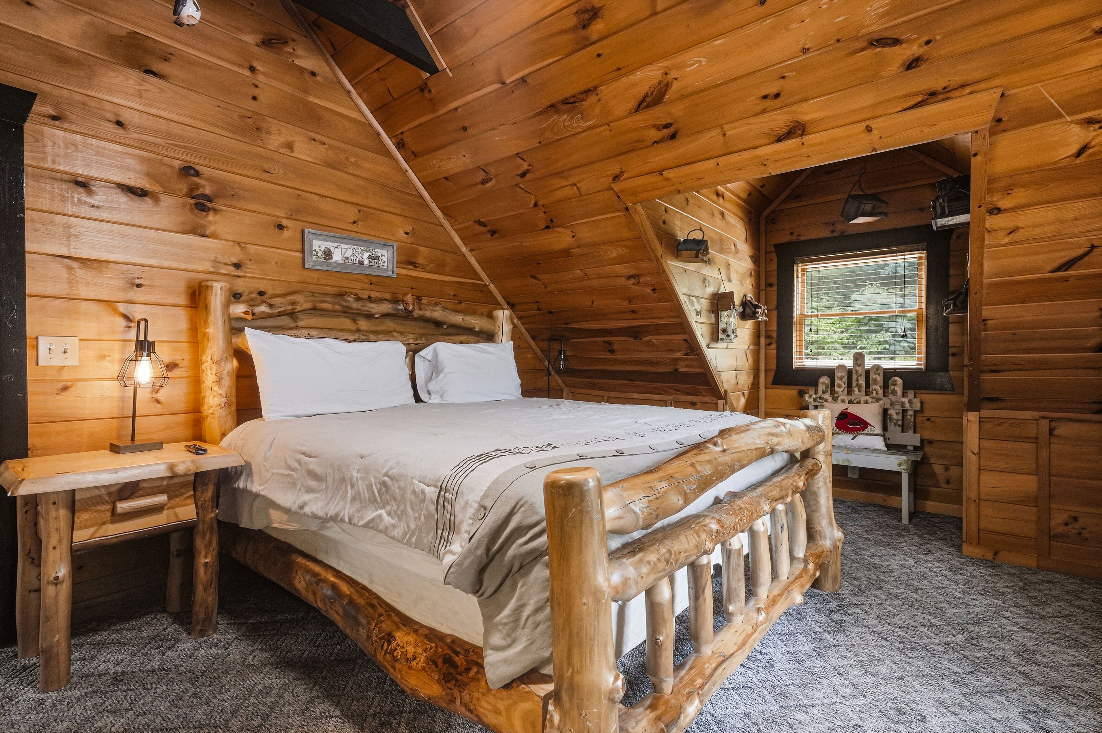 Upper-level king bedroom with TV and private ensuite bath